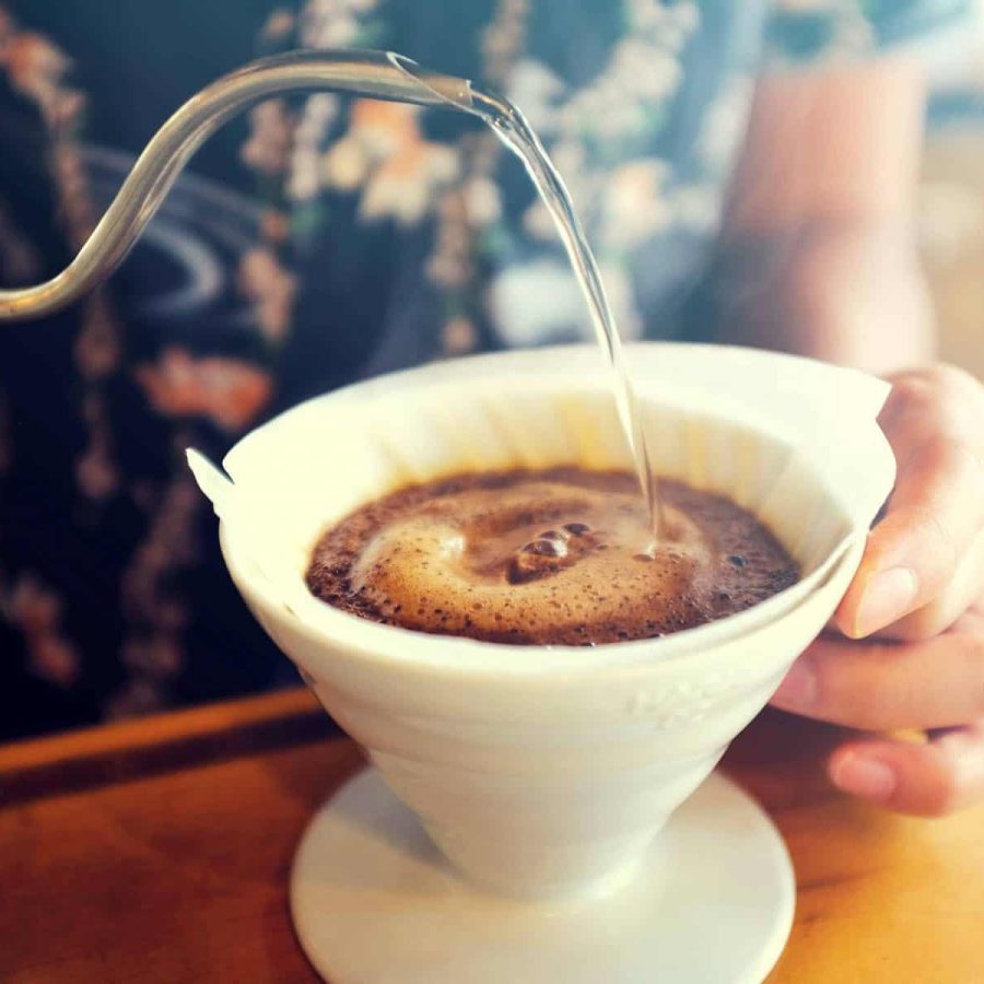 Hand Drip Coffee, Barista pouring hot water on roasted coffee ground with filter